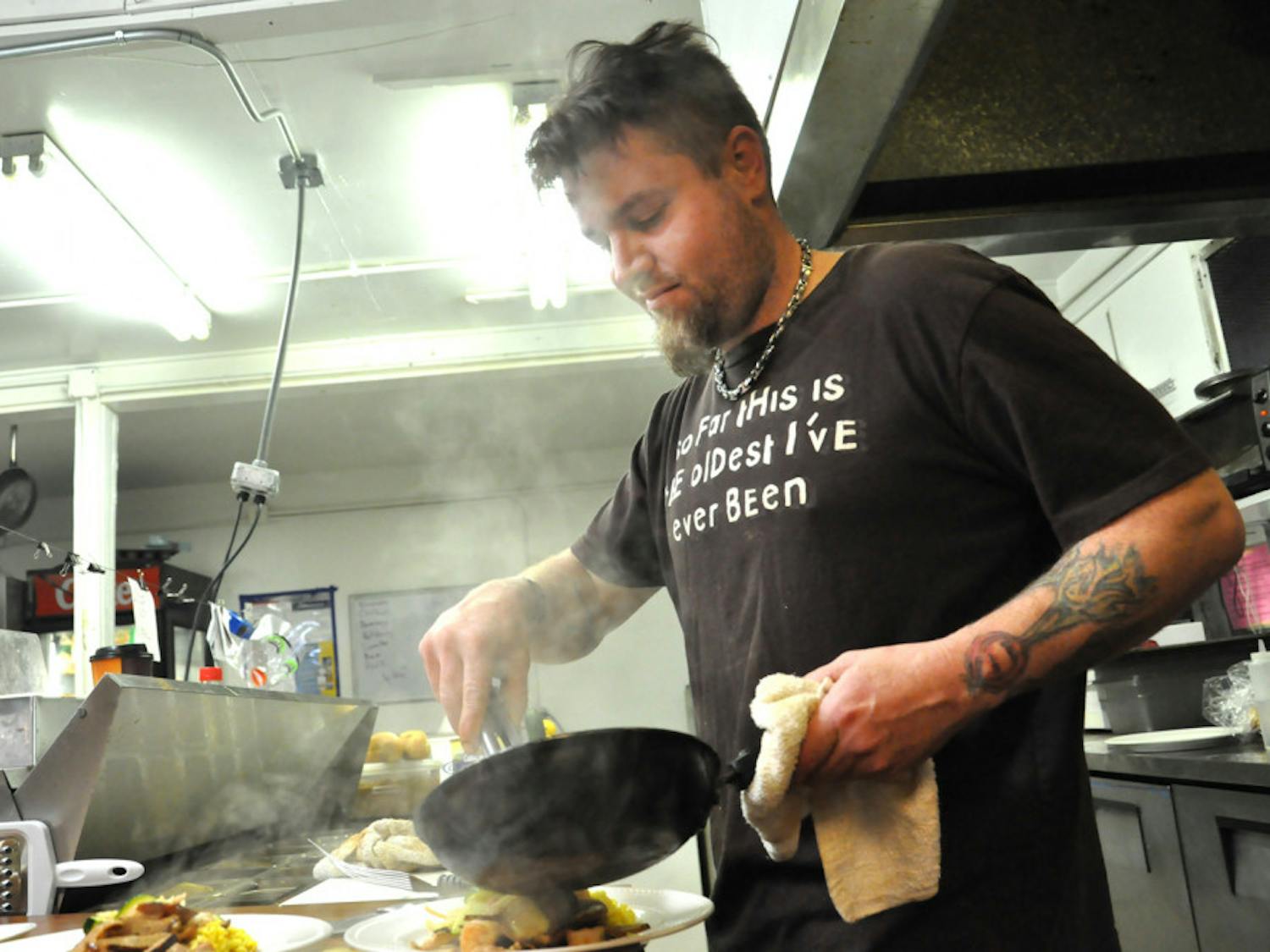 Chuck Hurley fills a lunch order at Kickin’ Devil Cafe, 2017 NE 27th Ave. He’s been working as a chef for more than half his life in Gainesville, New York and Paris.