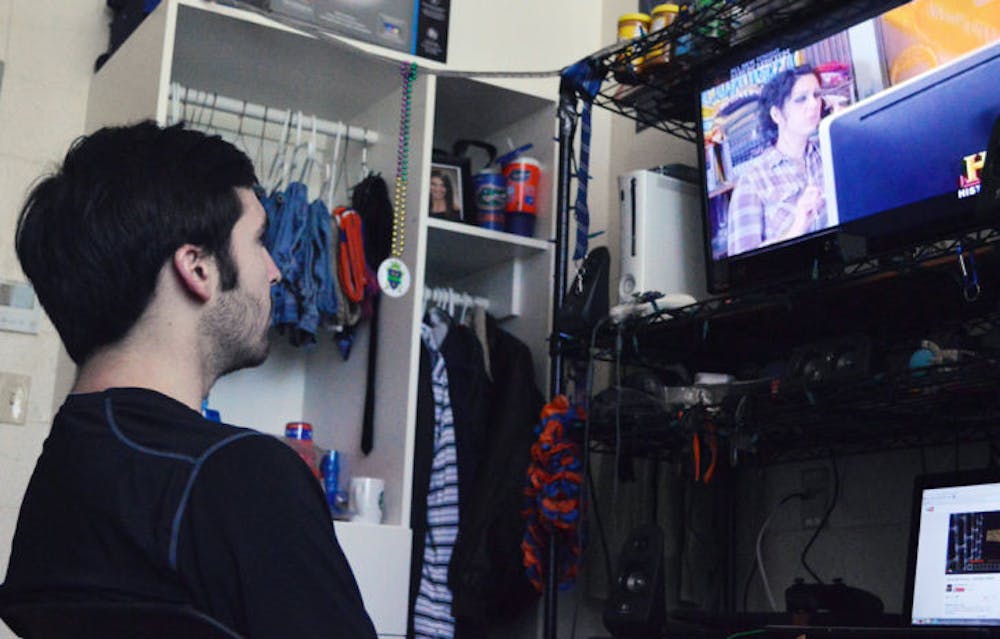 <p class="p1">Tyler Ritz, a 19-year-old UF aerospace engineering sophomore, watches the History Channel’s “American Pickers” in his first-floor Simpson Hall room Wednesday afternoon. A recent study by consulting firm Deloitte found that millennials watch less TV than older people do.</p>