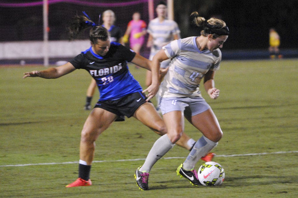 <p>Meggie Dougherty Howard attempts to get the ball from a Vanderbilt player during UF's 6-1 win on Thursday.</p>