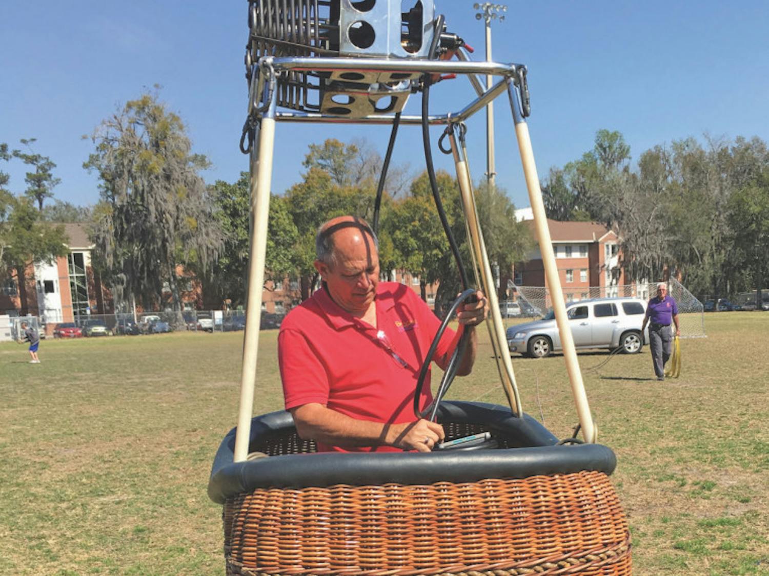 Bob Carlton, the owner of Balloons and Beyond, disassembles his hot air balloon on Flavet Field after about an hour and half of balloon rides on Friday. Carlton volunteered to bring his balloon to help raise awareness of mental health at the Onward and Upward event, hosted by the UF Bateman team.
&nbsp;
