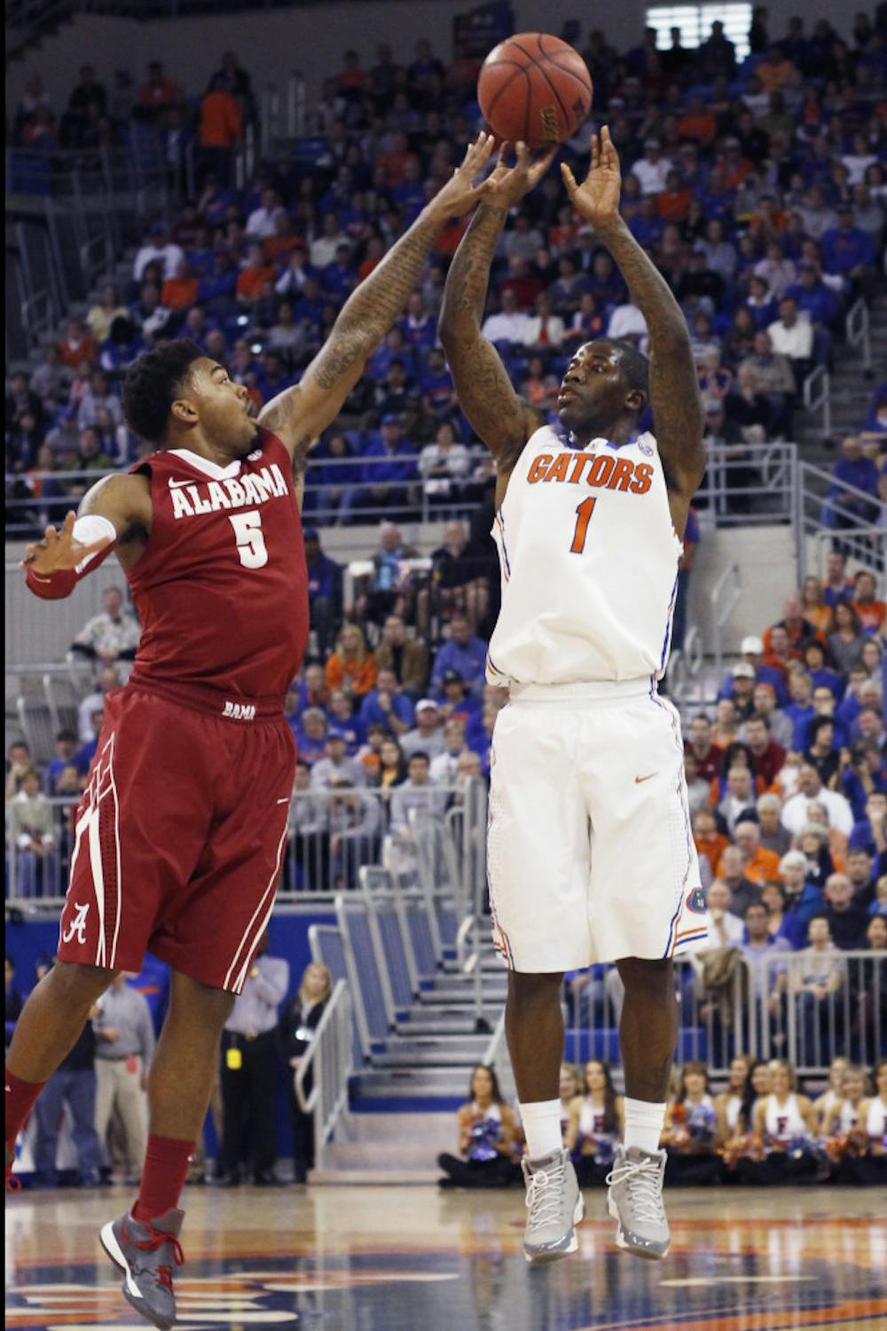 <p>Kenny Boynton attempts a shot over the outstretched arm of an Alabama defender. Boynton ranks No. 2 on Florida's all-time scoring list.</p>