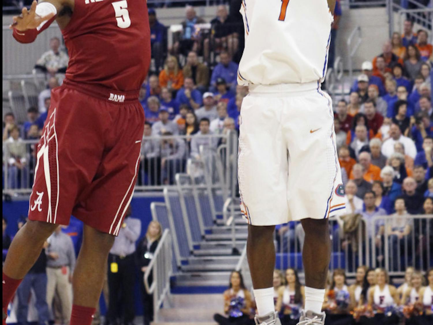 Kenny Boynton attempts a shot over the outstretched arm of an Alabama defender. Boynton ranks No. 2 on Florida's all-time scoring list.