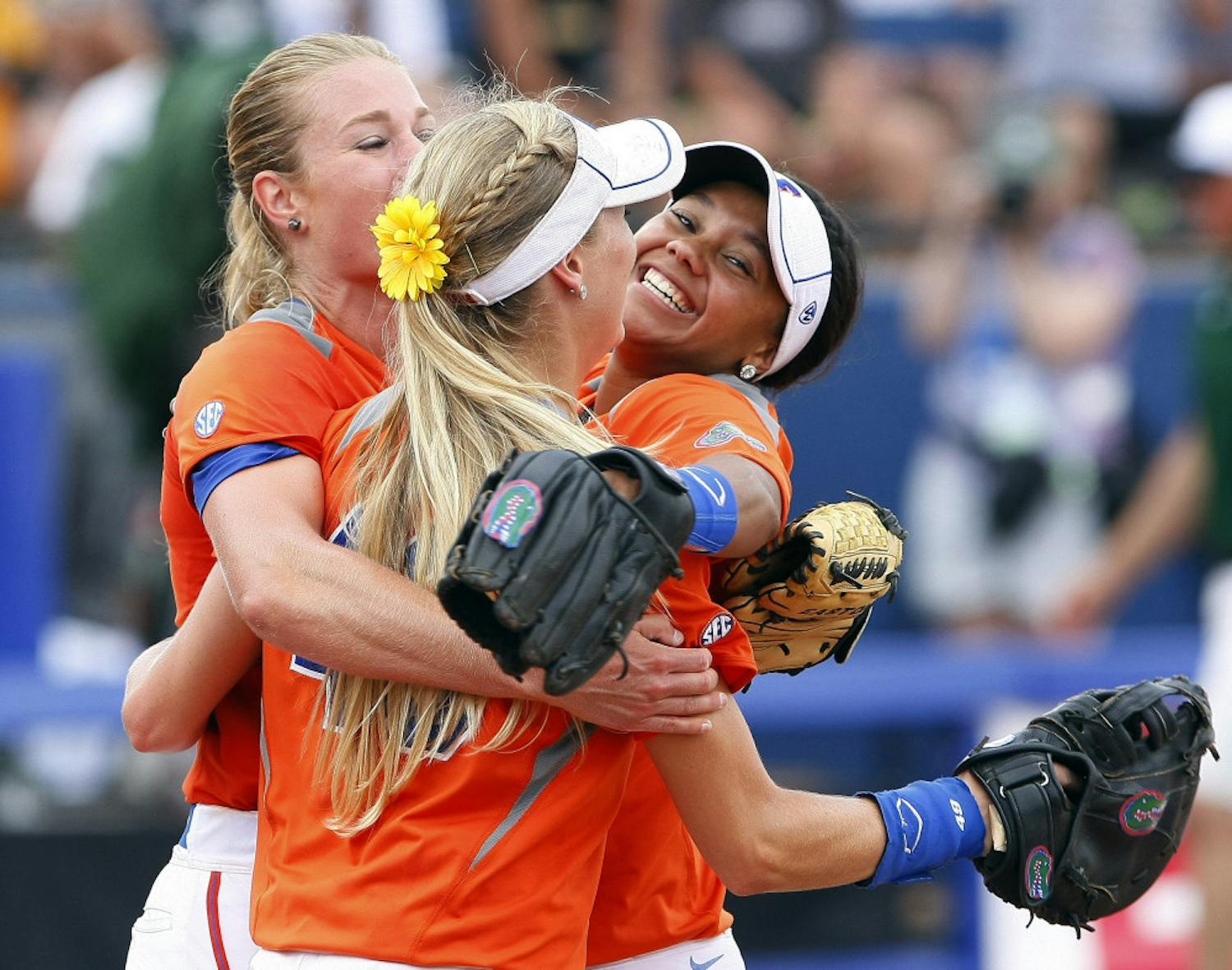 Florida pitcher Hannah Rogers, Taylor Schwarz, front, and Kelsey Stewart, right, celebrate after defeating Baylor 6-3 on Sunday.