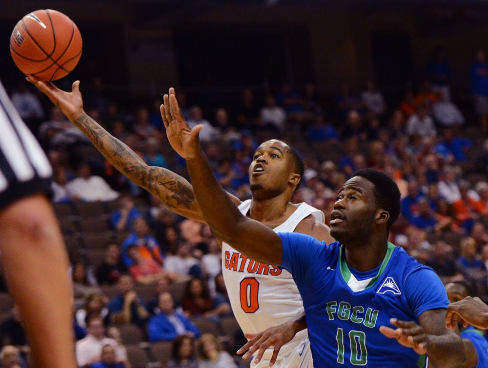 <p>Florida guard Kasey Hill drives to the basket as Florida Gulf Coast forward Kevin Mickle defends during the first half of an NCAA college basketball game, Friday Nov. 11, 2016, in Jacksonville, Fla. (Bob Mack/The Florida Times-Union via AP)</p>