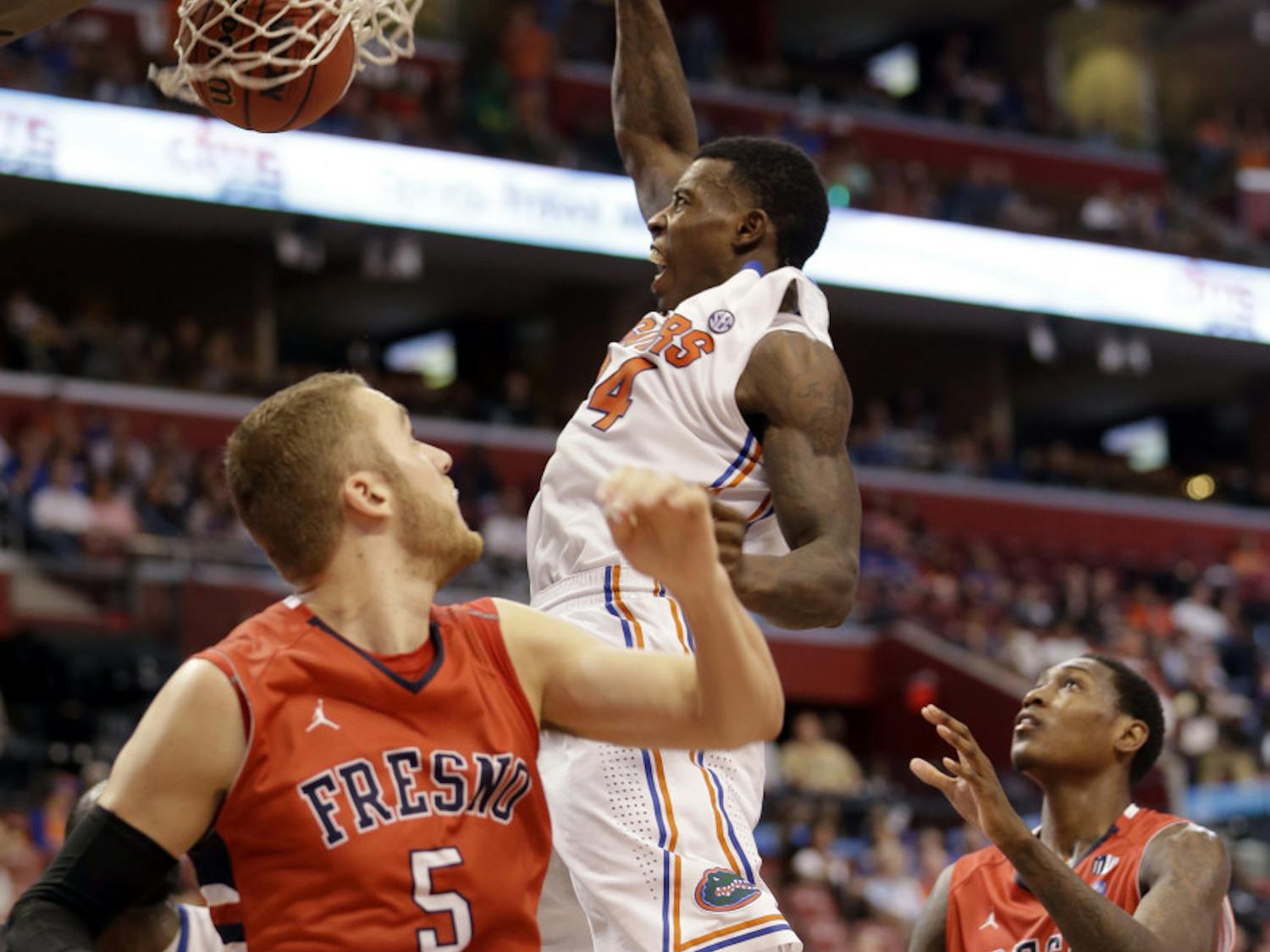 Casey Prather (24) scores against Fresno State's Tanner Giddings (5) and Alex Davis (10) during No. 16 Florida's 66-49 win at the Orange Bowl Basketball Classic on Dec. 21 in Sunrise.