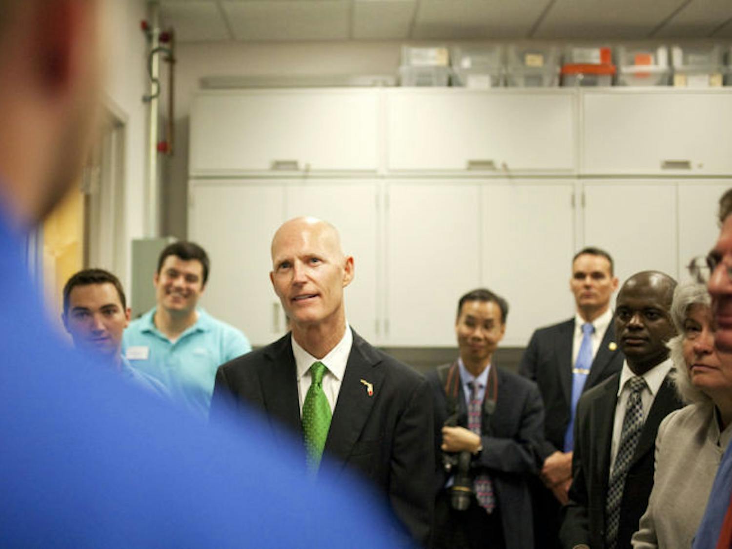 Gov. Rick Scott speaks to a UF senior during his tour of the university’s Nanoscale Research Facility. Scott plans to give UF about $15 million annually for the next five years.