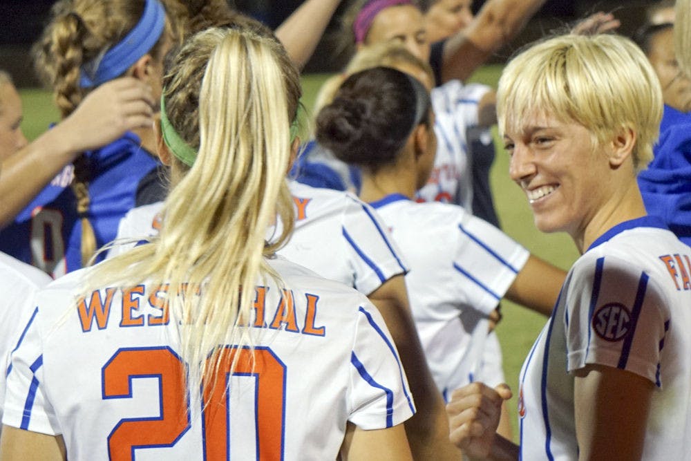 <p>UF defender Claire Falknor smiles with fellow senior Christen Westphal following the final regular-season home game of their UF careers.</p>