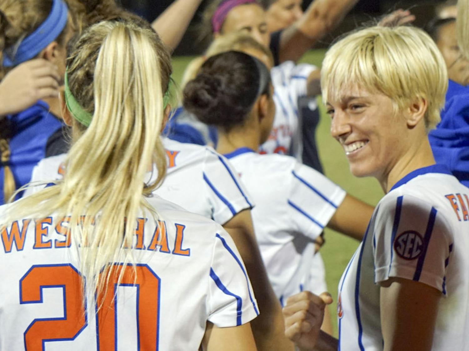 UF defender Claire Falknor smiles with fellow senior Christen Westphal following the final regular-season home game of their UF careers.