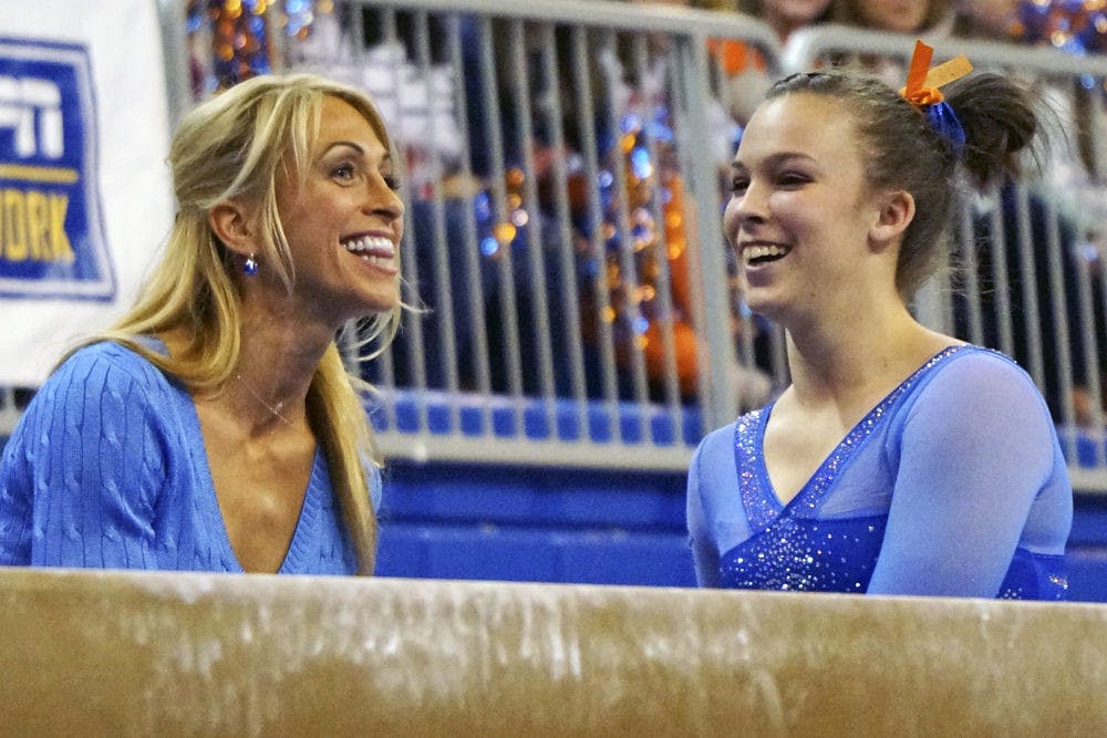 Rhonda Faehn congratulates freshman Ericha Fassbender following her balance beam routine during Florida's 197.60-196.95 win against Georgia on Jan. 30 in the O'Connell Center.