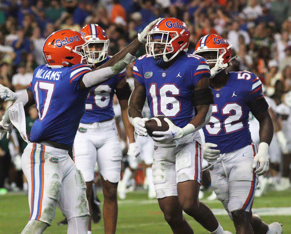 Linebacker Scooby Williams celebrates with defensive back Tre’Vez Johnson, who brought in a clutch interception during Florida’s win over South Florida Saturday, Sept. 17, 2022.