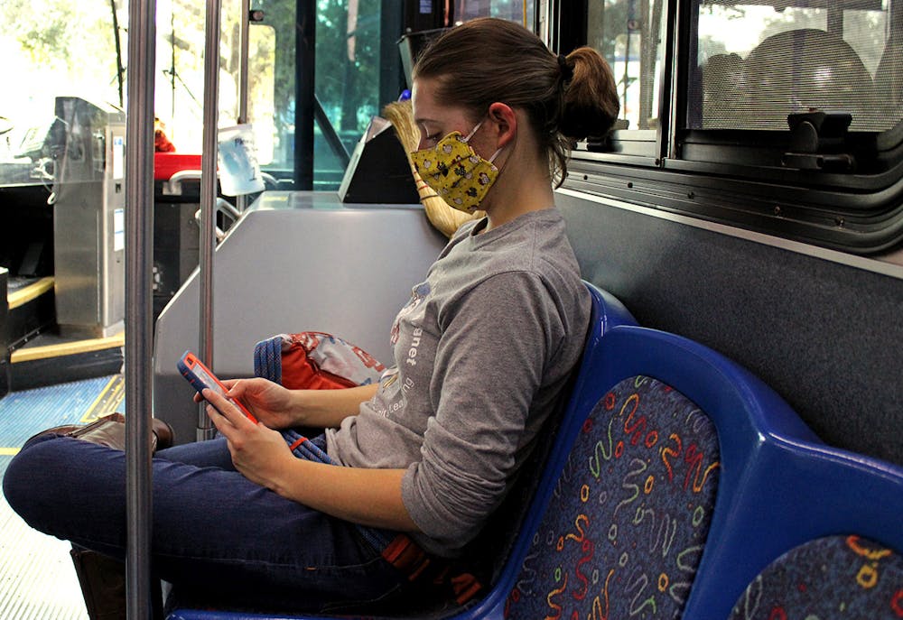 <p>Lillie Rooney, a 20-year-old UF Entomology senior, sits on  RTS Bus 35 at the J. Wayne Reitz Union stop on campus on Sunday, Jan. 10, 2021. RTS is adding more buses to existing routes 12, 13, 20 and 38, continuing mask mandates and keeping capacities low for buses this Spring.</p>