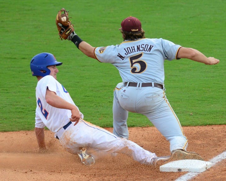 Sophomore Casey Turgeon attempts a slide into third against Bethune-Cookman last season as Nick Johnson receives the throw. Turgeon and freshman Harrison Bader carried the Florida offense on Tuesday night in Jacksonville. Bader had his first career three-hit game.
