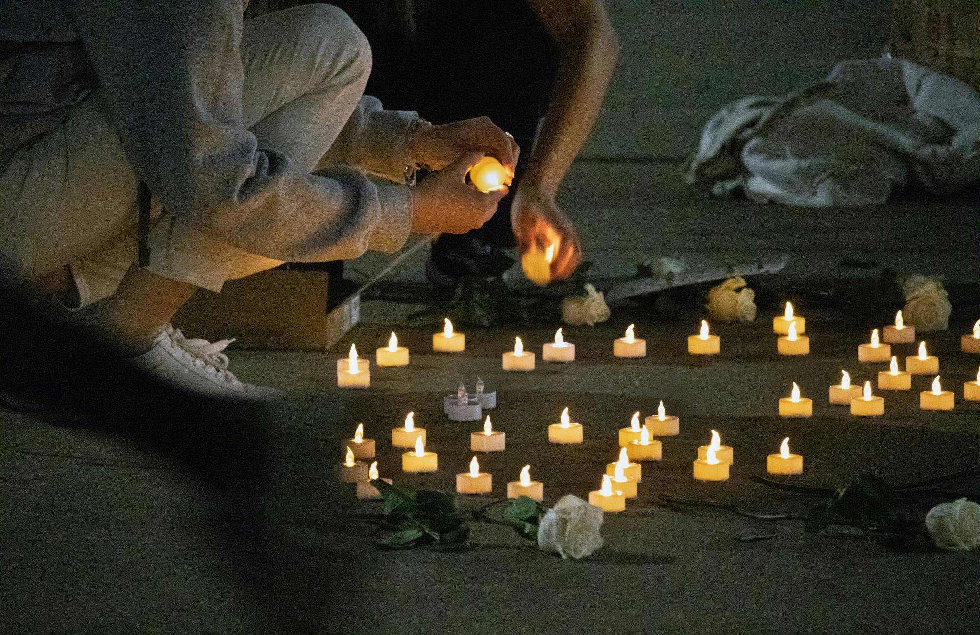 UF Turkish Student Association members turn off candles as the vigil dedicated to those who died during the Turkey-Syria earthquakes draws to a close Thursday, March 2, 2023.
