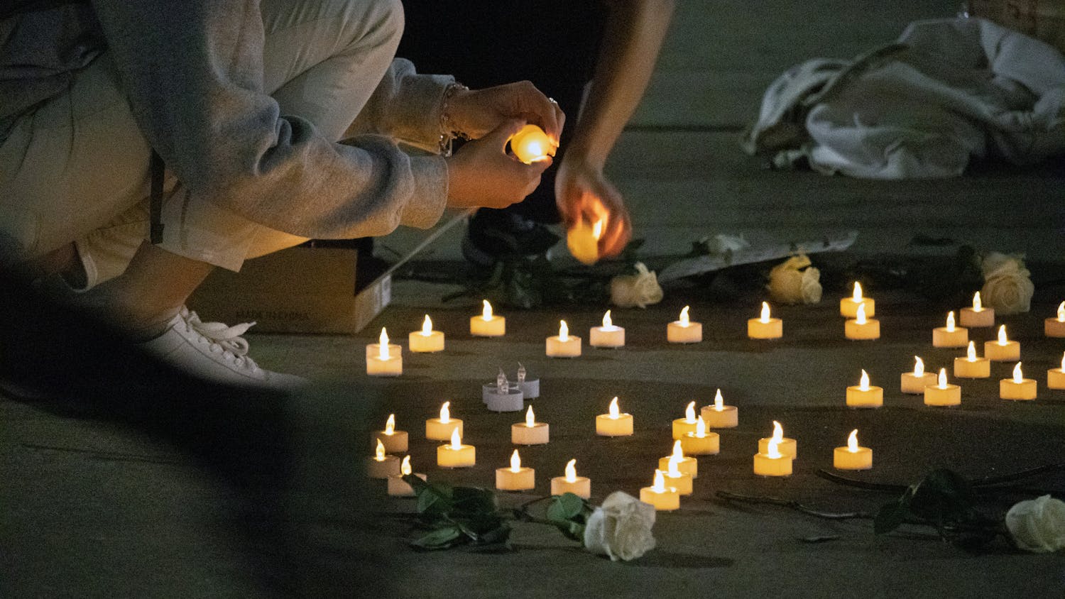 UF Turkish Student Association members turn off candles as the vigil dedicated to those who died during the Turkey-Syria earthquakes draws to a close Thursday, March 2, 2023.