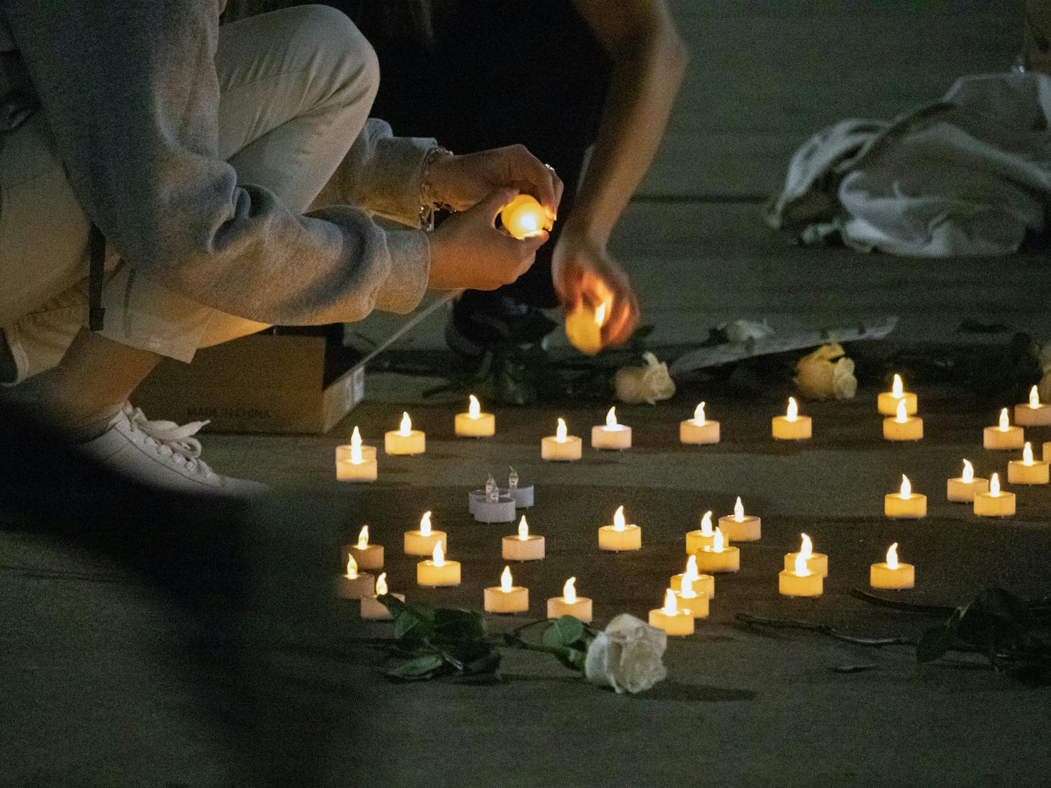 UF Turkish Student Association members turn off candles as the vigil dedicated to those who died during the Turkey-Syria earthquakes draws to a close Thursday, March 2, 2023.