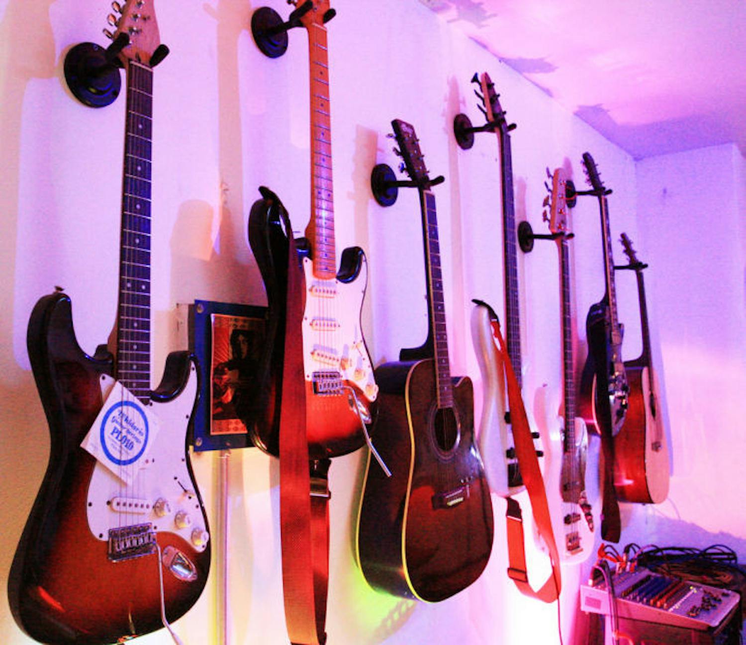 Guitars hang on the wall of The JAM, 817 W. University Ave., waiting to be played by patrons. Anyone can use the bar’s instruments, which include guitars, drums and a piano, to rock on the stage.