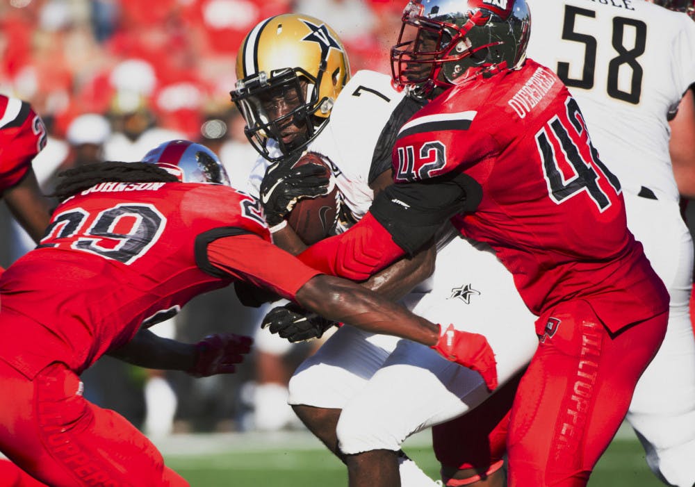 Vanderbilt University running back Ralph Webb (7) is tackled by multiple Western Kentucky University players in an NCAA college football game, Saturday, Sept. 24, 2016, in Bowling Green, Ky. (AP Photo/Michael Noble Jr.)