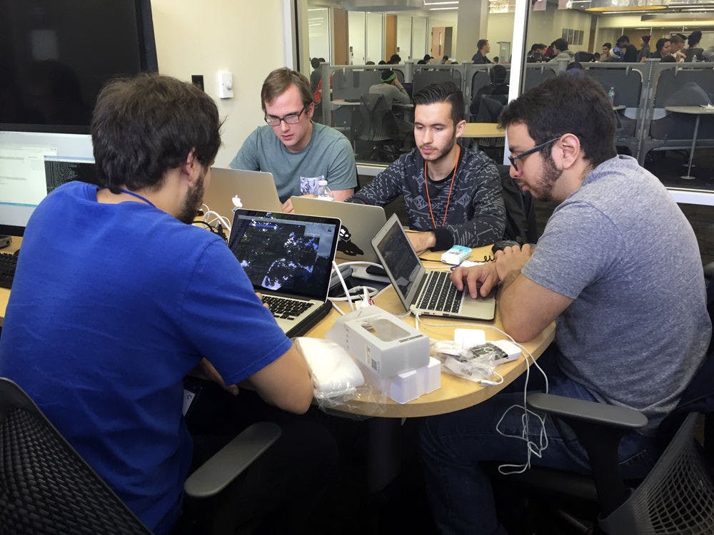 <p>From left: Bradley Treuherz, a 21-year-old UF computer engineering junior, Anthony Colas, a 21-year-old UF computer engineering senior, Sergio Puleri, 20-year-old UF computer science junior, and Max Fresonke, a 21-year-old UF computer engineering junior, compete at SwampHacks on Saturday. The team won second place for their program, which recognizes people's faces and plays their favorite song.</p>