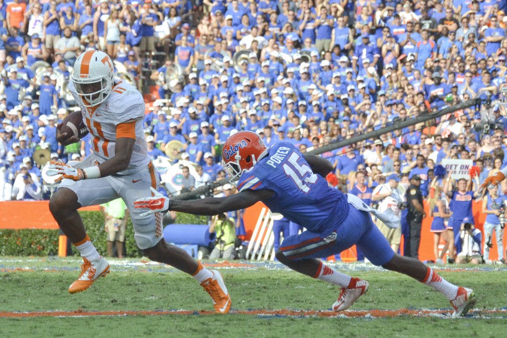 <p>UF defensive back Deiondre Porter misses a tackle on Tennessee quarterback Josh Dobbs during Florida's 28-27 win on Sept. 26, 2015, at Ben Hill Griffin Stadium.</p>