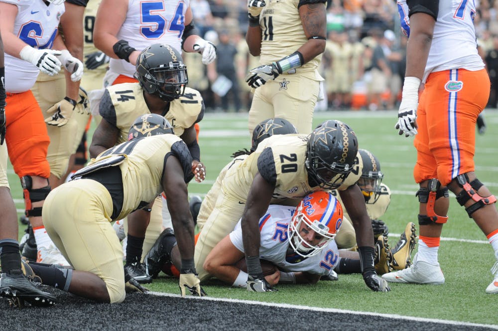 <p>Quarterback Austin Appleby (12) is tackled by a Vanderbilt defender short of the goal line during Florida's 13-6 win over the Commodores on Oct. 1, 2016, at Vanderbilt Stadium.</p>