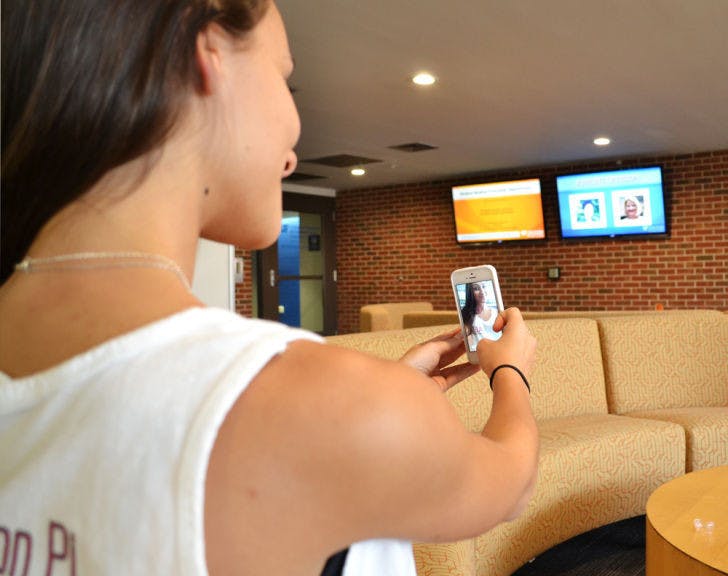 Emma Neagu, a 19-year-old UF telecommunication junior, takes a selfie using Snapchat on Thursday morning in Weimer Hall. The app is becoming a recruiting tool.