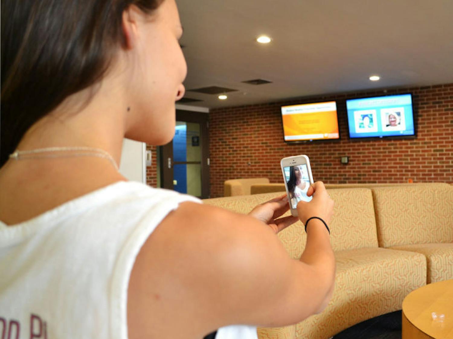 Emma Neagu, a 19-year-old UF telecommunication junior, takes a selfie using Snapchat on Thursday morning in Weimer Hall. The app is becoming a recruiting tool.