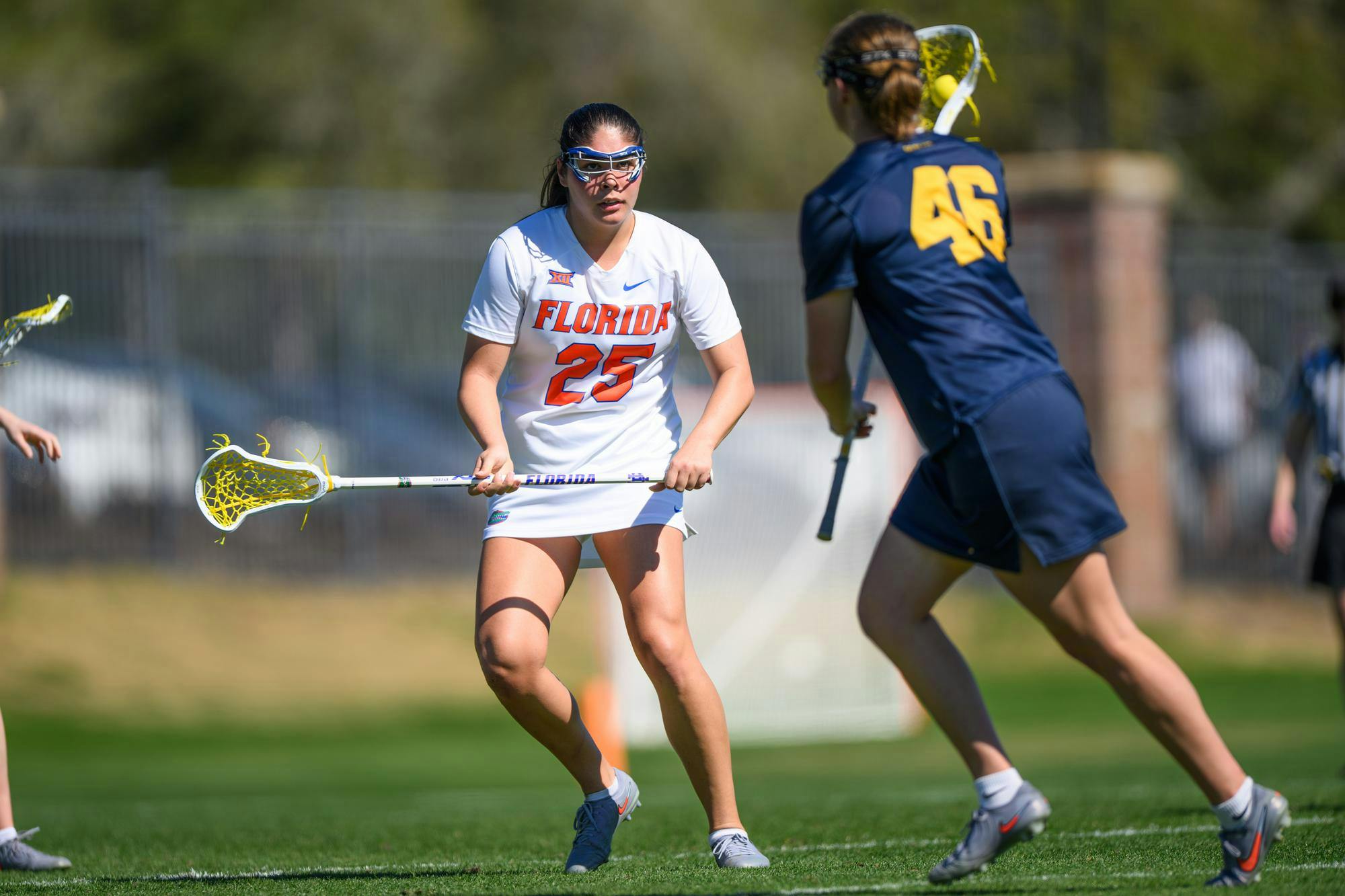 Florida defender Theresa Bragg (25) defends during the second half of an NCAA lacrosse match against Michigan, Friday, Feb. 13, 2026, in Gainesville, Fla.