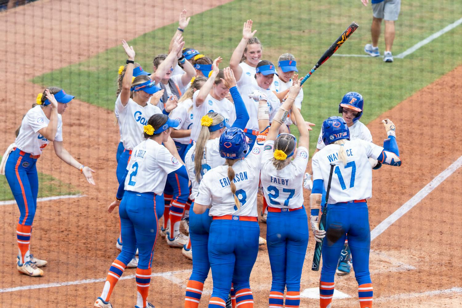 The Florida Gators softball team met junior left fielder Korbe Otis at the plate after she hit a solo home run during the Gators' 4-2 win over Baylor on Friday, May 24, 2024. 