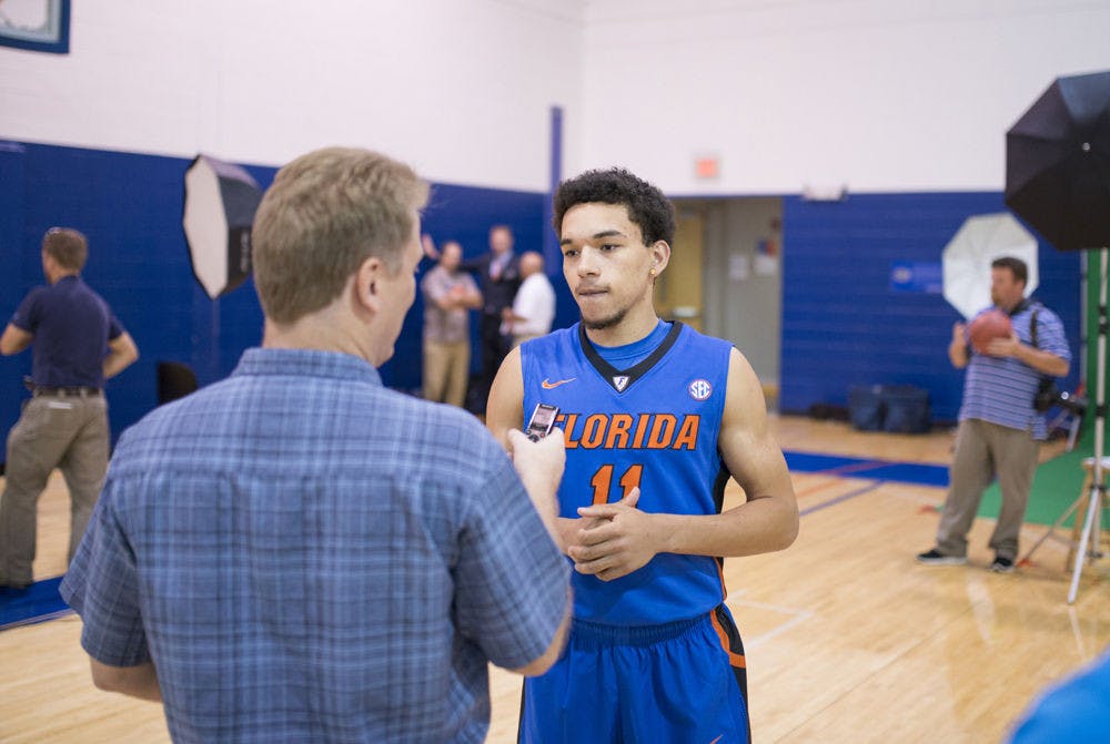 <p>Chris Chiozza (11) speaks with Kevin Brockway of the Gainesville Sun during the 2014 UF men's basketball media day on Oct. 15.</p>