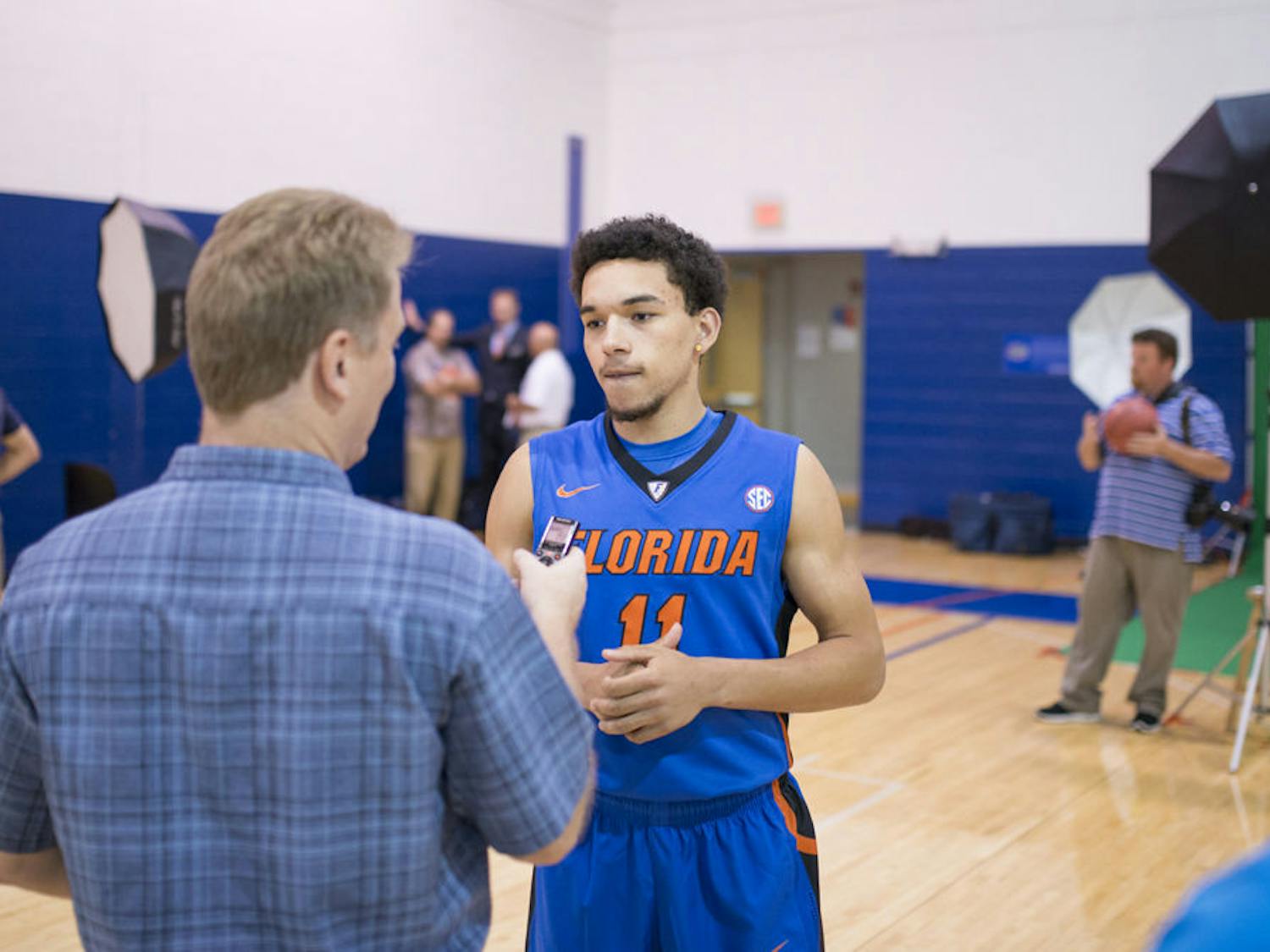 Chris Chiozza (11) speaks with Kevin Brockway of the Gainesville Sun during the 2014 UF men's basketball media day on Oct. 15.