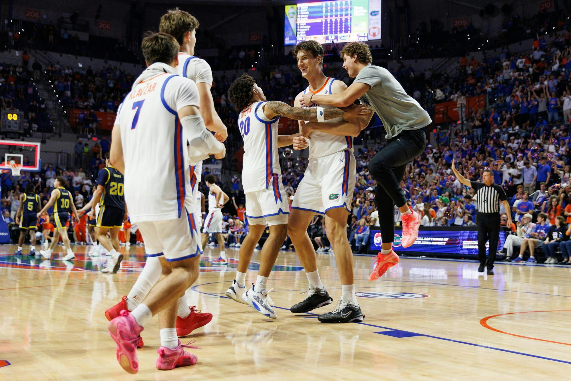 Florida Gators center Olivier Rioux (32) celebrates with his teammates after scoring his first career point in a game against Merrimack, Friday, Nov. 21, 2025, in Gainesville, Fla.Gainesville, Fla.
