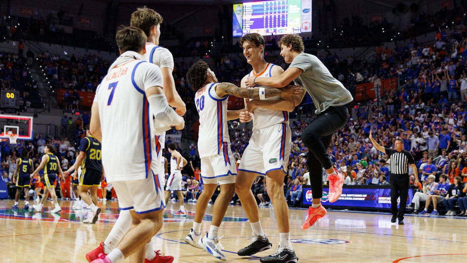 Florida Gators center Olivier Rioux (32) celebrates with his teammates after scoring his first career point in a game against Merrimack, Friday, Nov. 21, 2025, in Gainesville, Fla.Gainesville, Fla.