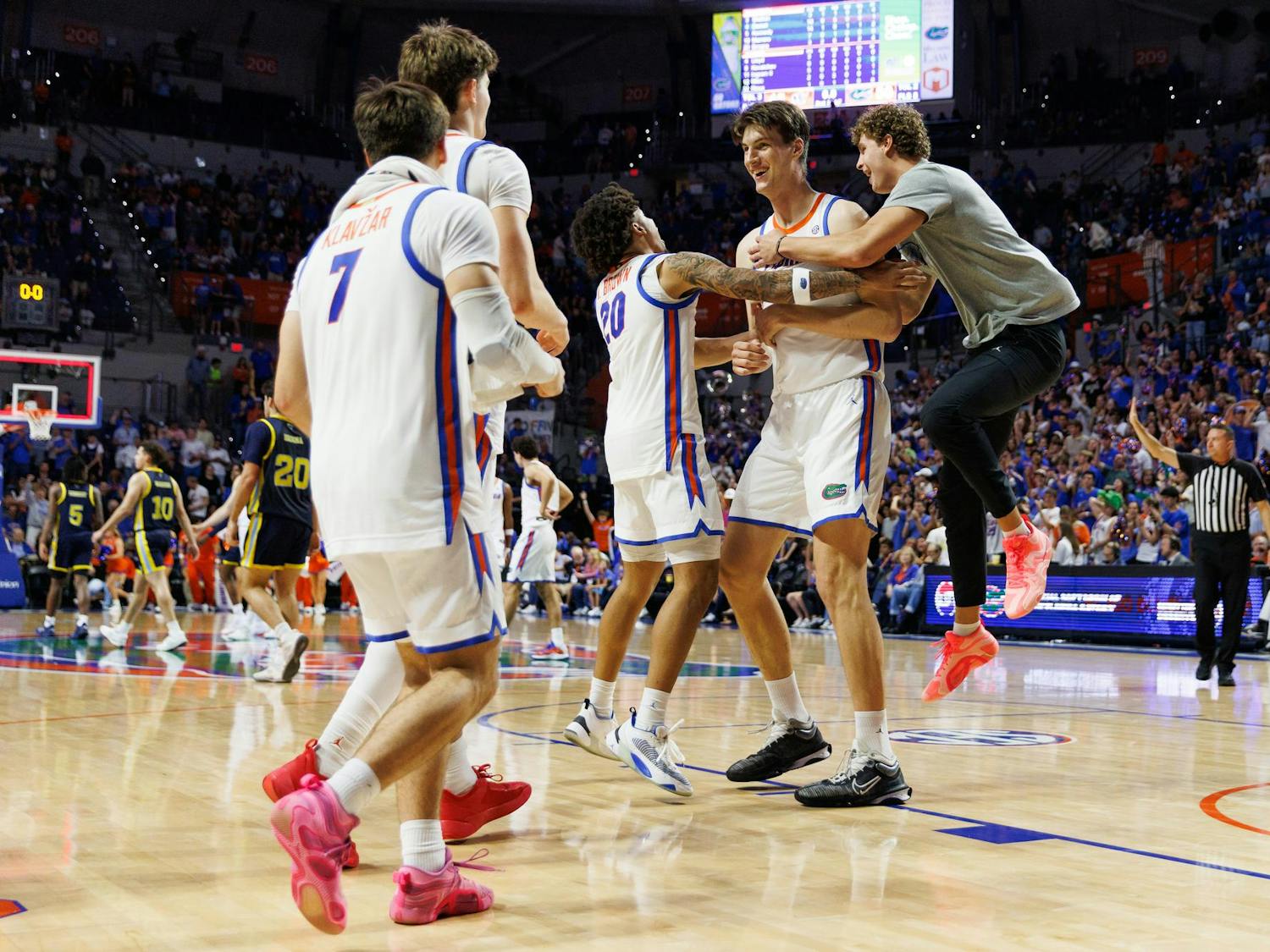 The Florida Gators men's basketball team celebrates with Florida Gators center Olivier Rioux (32) after a NCAA college basketball game against Merrimack, Friday, Nov. 21, 2025, in Gainesville, Fla.