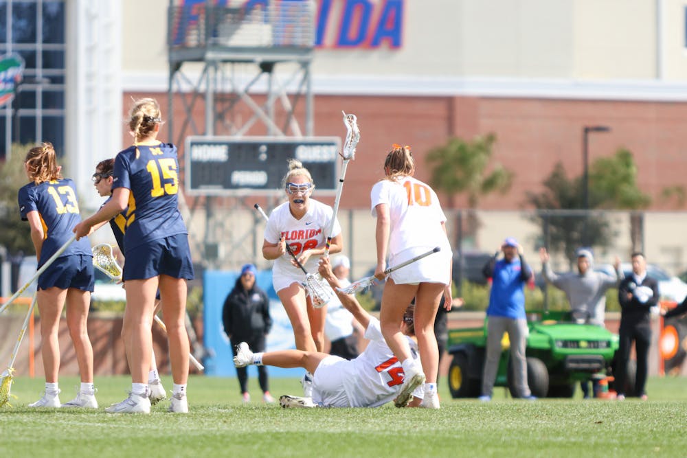 The Florida lacrosse team celebrates a goal in the Gators' 17-8 win against the Michigan Wolverines Sunday, Feb. 12, 2023