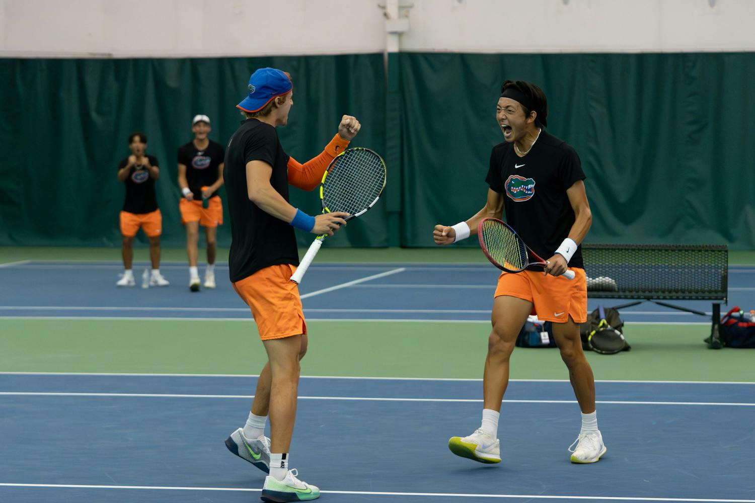 Gators men's tennis pairing of junior Nate Bonetto and freshman Aidan Kim celebrate winning a point in their match against Ole Miss on Friday, March 22, 2024. 