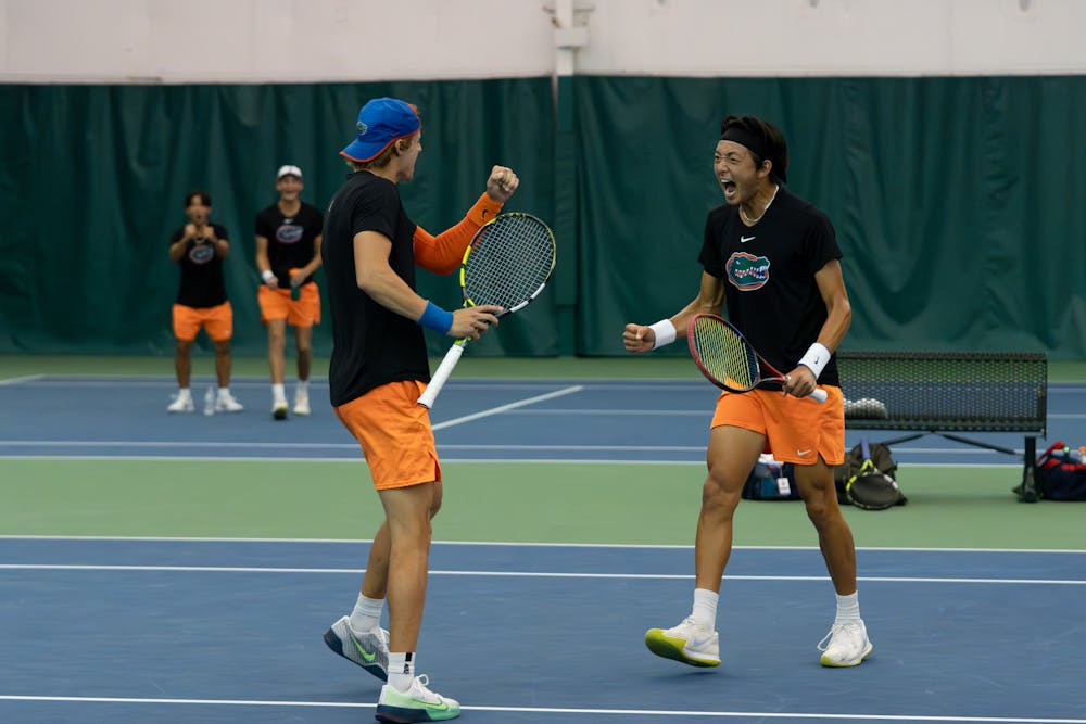 Gators men's tennis pairing of junior Nate Bonetto and freshman Aidan Kim celebrate winning a point in their match against Ole Miss on Friday, March 22, 2024. 