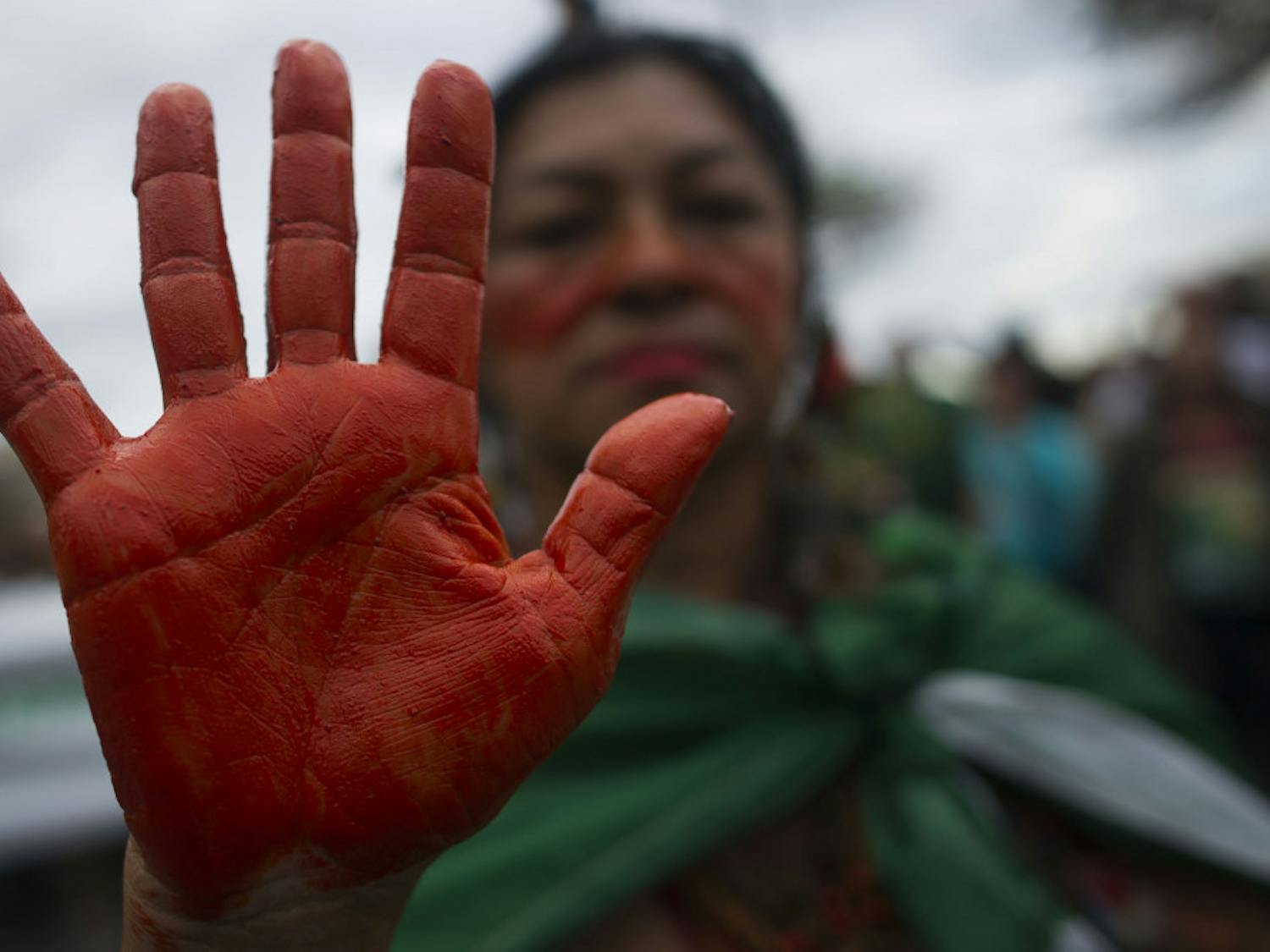 An indigenous woman shows her hands painted in red, representing blood, during a protest in defense of the Amazon while wildfires burn in that region, in Rio de Janeiro, Brazil, Sunday, Aug, 25, 2019. Experts from the country's satellite monitoring agency say most of the fires are set by farmers or ranchers clearing existing farmland, but the same monitoring agency has reported a sharp increase in deforestation this year as well. (AP Photo/Bruna Prado)
