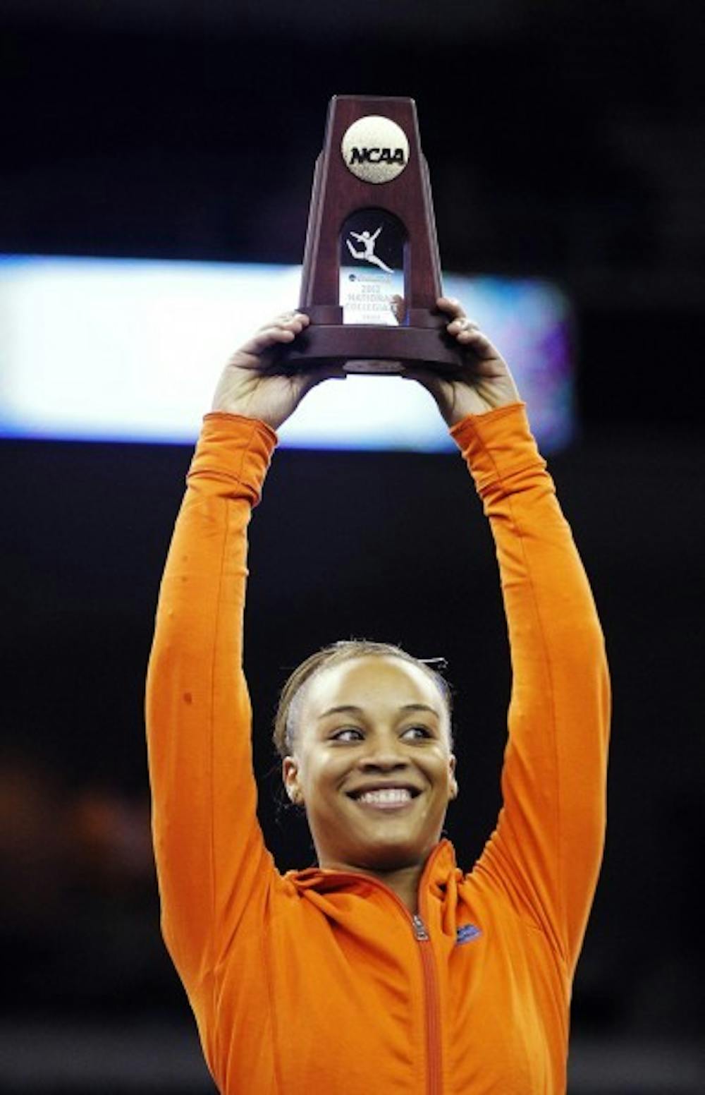 <p>Florida freshman gymnast Kytra Hunter lifts the trophy she earned for winning the NCAA vault national title Sunday.</p>