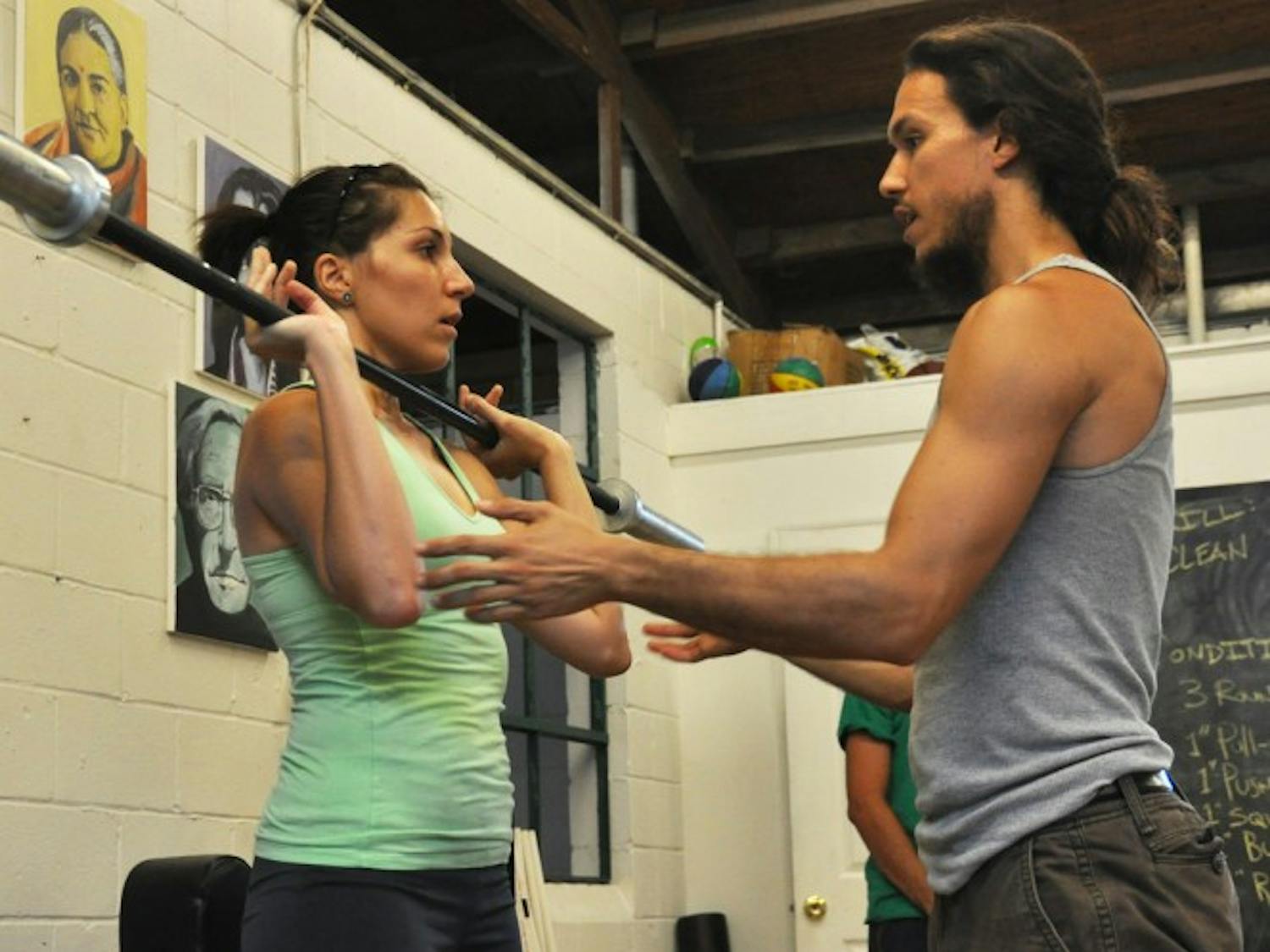 Maria Trujillo, a 25-year-old UF alumna, takes instruction from Michael Espinosa, a 27-year-old UF alumnus and founder of The Ark School of Fitness, 22 NE 11 St. The Ark gym is a nonprofit facility.