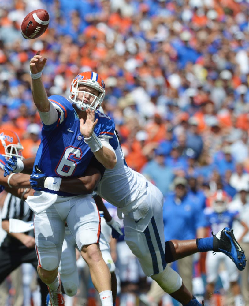 Florida quarterback Jeff Driskel (6) attempts a pass while being hit by a UK defender during UF’s 38-0 win on Saturday in Ben Hill Griffin Stadium. Since Texas A&amp;M sacked the sophomore eight times on Sept. 8, Driskel improved his pocket presence against Tennessee and Kentucky by getting sacked only three times.
