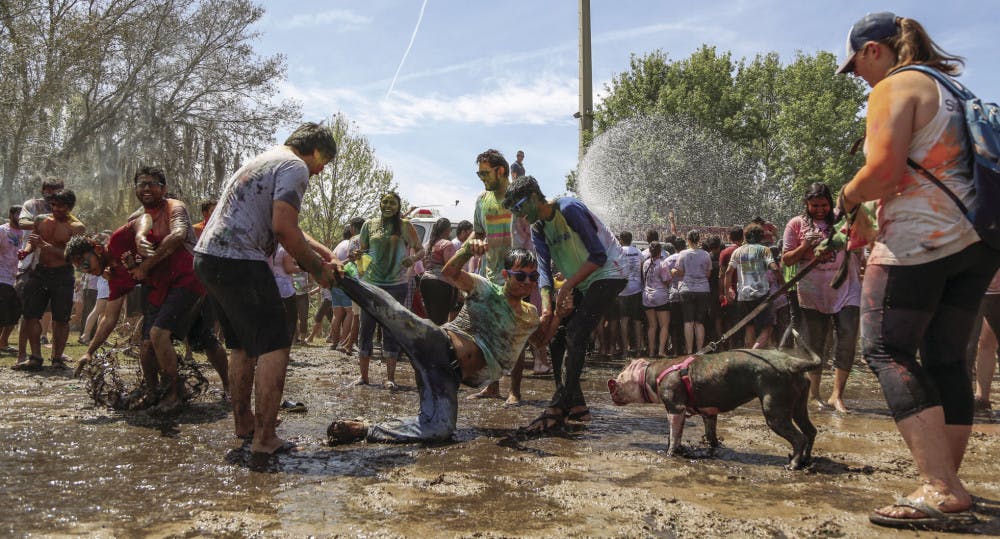 Participants of the 2017 UF Holi Festival of Colors, organized by the Indian Student Association and Student Government, have a mud fight on Sunday afternoon on Flavet Field. After the kickoff, people went under water thrown by a fire truck.
&nbsp;