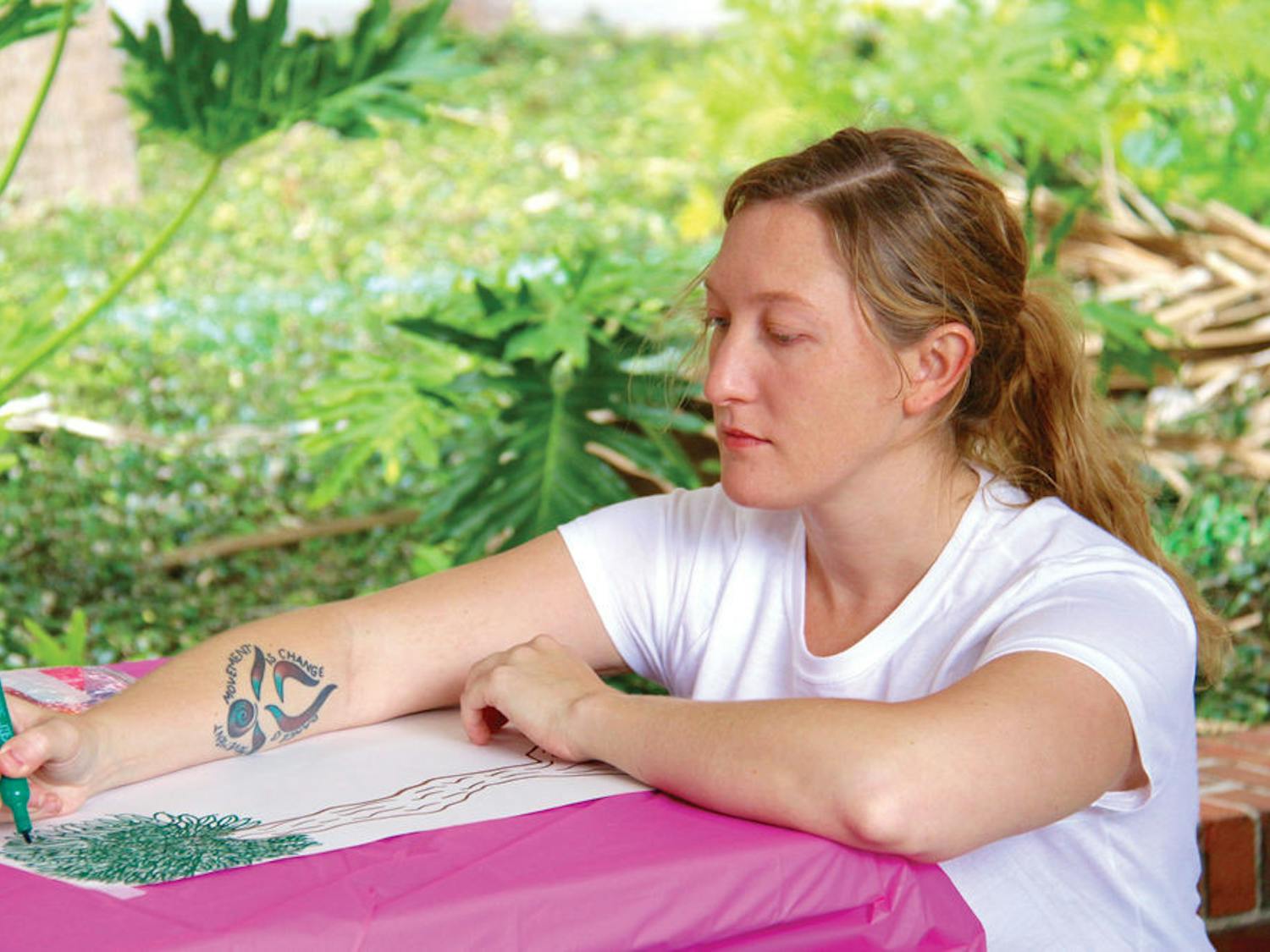 Lizzy Snow, a graduate intern with the Center for Arts and Medicine, draws a picture to support a research study hosted by 352 Creates. The 29-year-old will be running events for 352 Creates on Friday at The Midnight, including coloring book and collage making as well as instructing a hip-hop workshop.