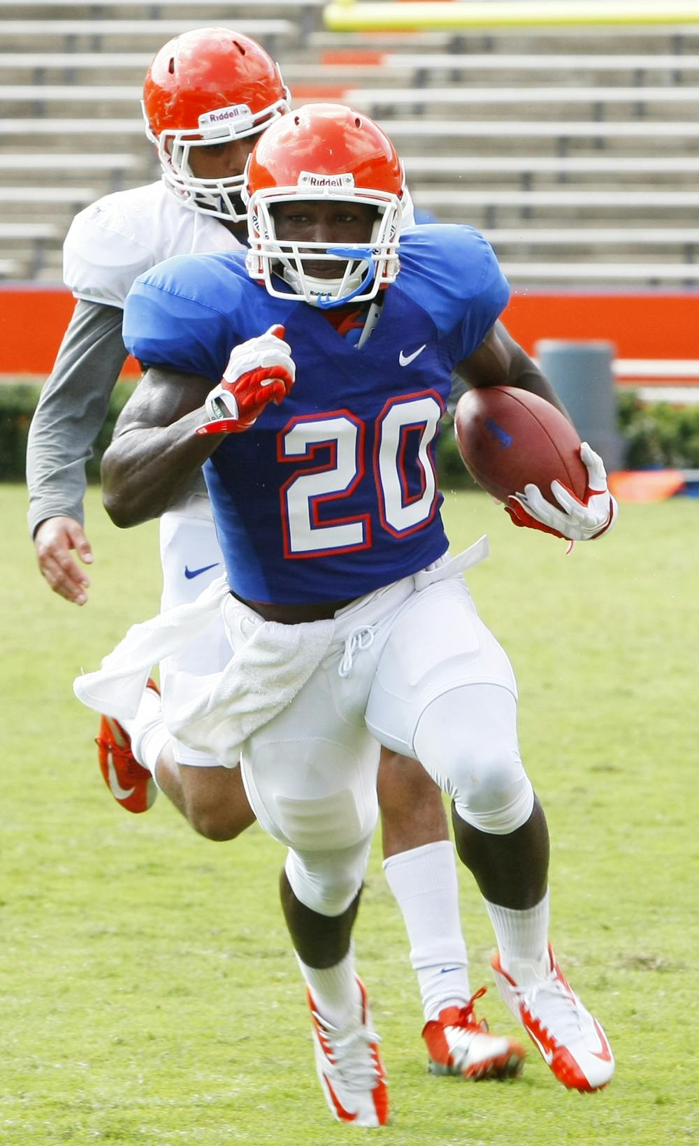 <p>Omarius Hines (20) runs the ball during a drill on Saturday during open practice at Ben Hill Griffin Stadium.</p>