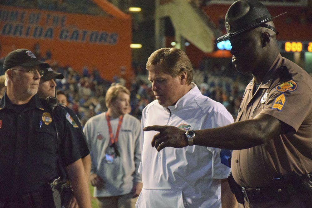 <p>UF Jim McElwain walks off the field following Florida's 27-2 loss to Florida State on Nov. 28, 2015, at Ben Hill Griffin Stadium.</p>