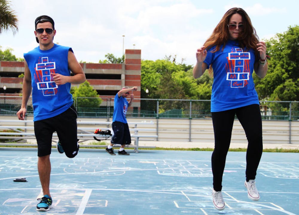 <p>Alejandro Saenz, 19, and Sophia Hannabergh, 19, hopscotch at UF’s Hopping 4 A Cure tournament at the Broward Hall Outdoor Recreation Complex on Sunday afternoon.</p>