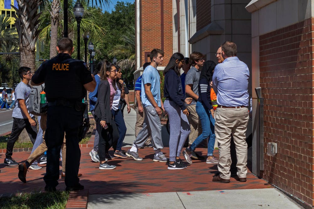 Students head back into Hernandez Hall after the evacuation order was lifted from the building. The entire building was forced to evacuate Wednesday afternoon after multiple students reported feeling lightheaded.