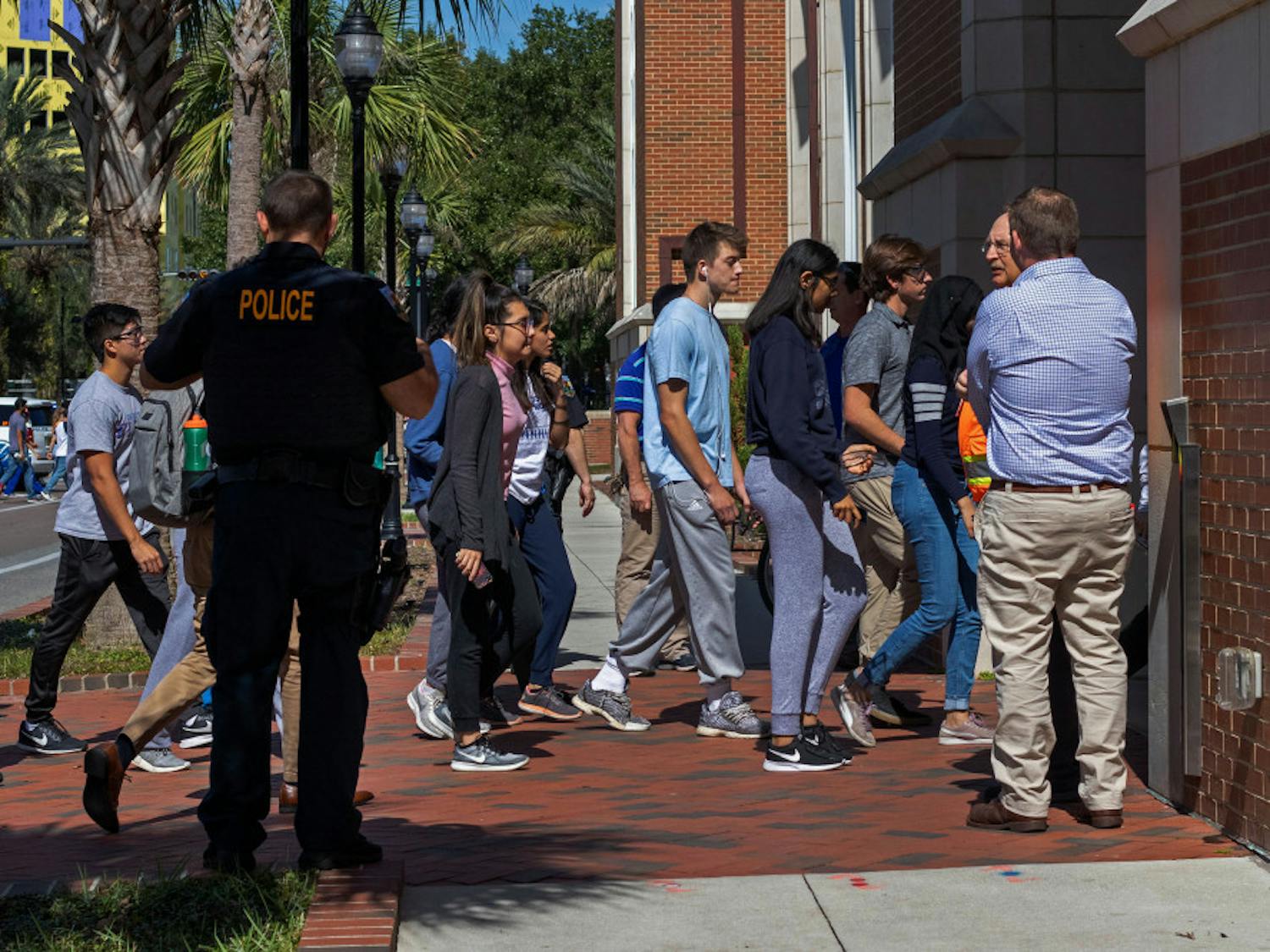 Students head back into Hernandez Hall after the evacuation order was lifted from the building. The entire building was forced to evacuate Wednesday afternoon after multiple students reported feeling lightheaded.