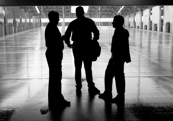 City Commissioner Todd Chase, center, speaks with John Wayne Mishoe, left, and Stephen Belser, right, of JWM Engineering LLC after a ribbon cutting ceremony celebrating the completion of the solar panel system installed in the Continuum apartments.
