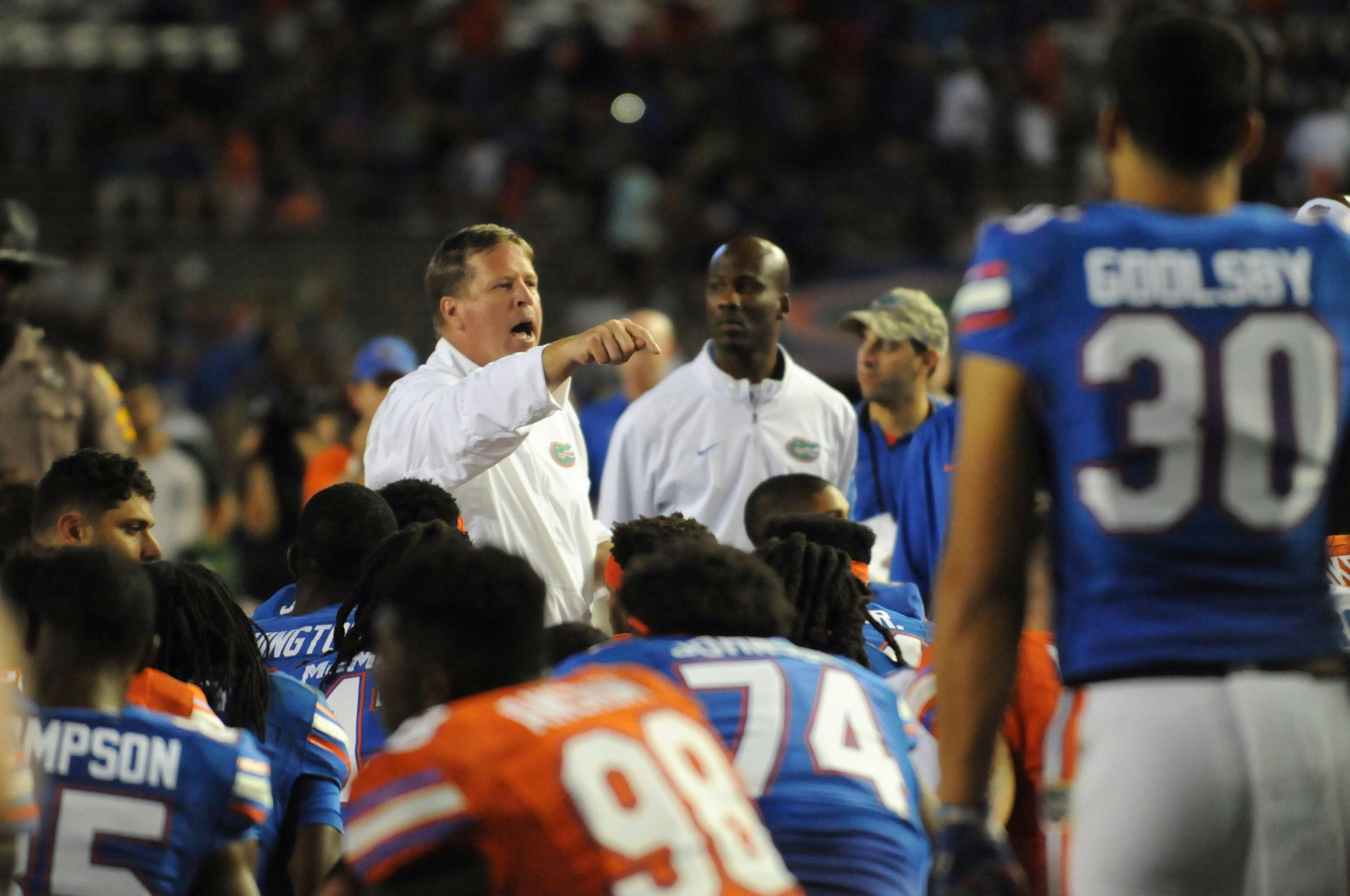 UF coach Jim McElwain talks with his team following the Orange &amp; Blue Debut on April 8, 2016, at Ben Hill Griffin Stadium.