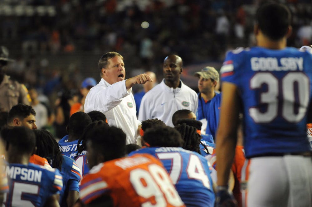 <p>UF coach Jim McElwain talks with his team following the Orange &amp; Blue Debut on April 8, 2016, at Ben Hill Griffin Stadium.</p>